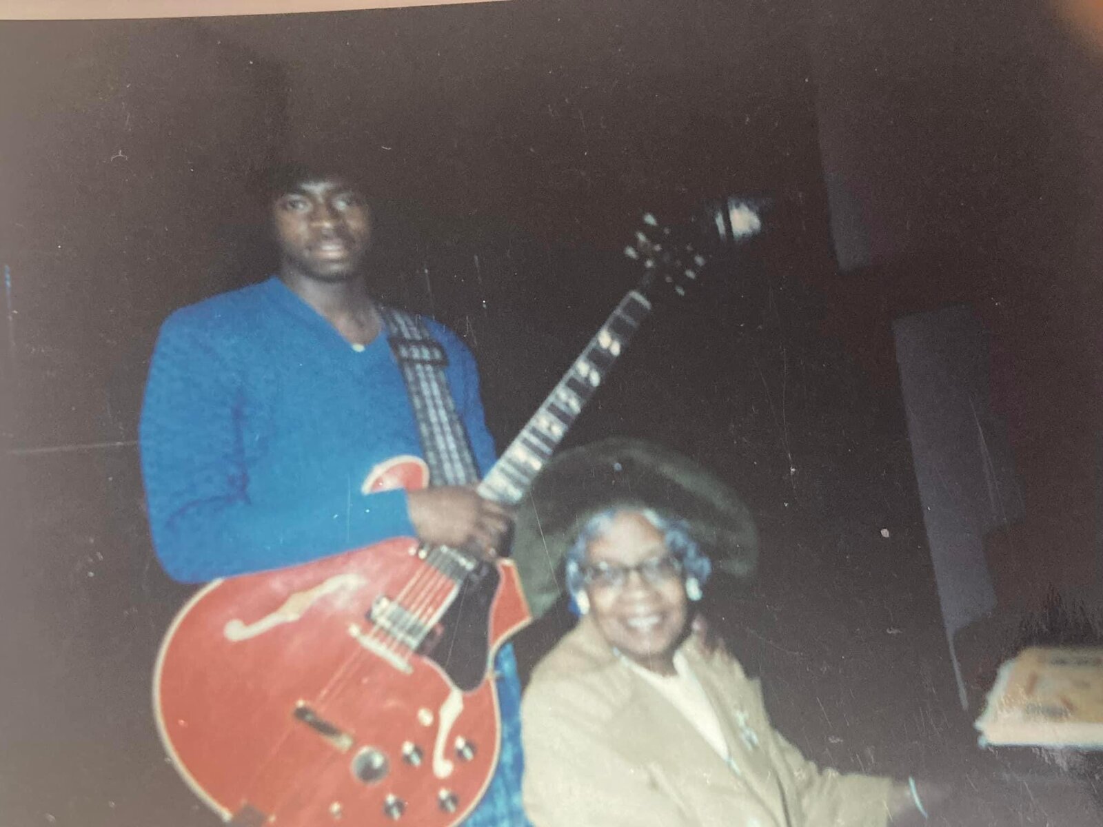 A young Wil A. Crosby holding a hollow-body guitar with Mrs. Lottie Shank